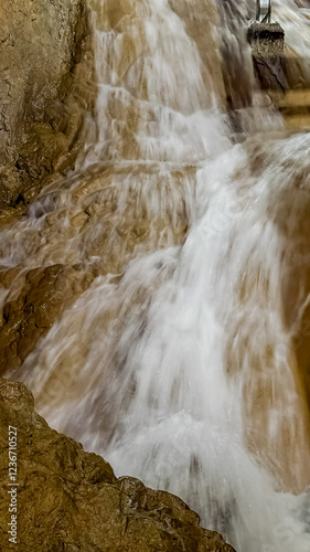 A scenic waterfall cascades over rocky terrain, symbolizing natural beauty and tranquility, perfect for Earth Day reflections  stopica pecina photo