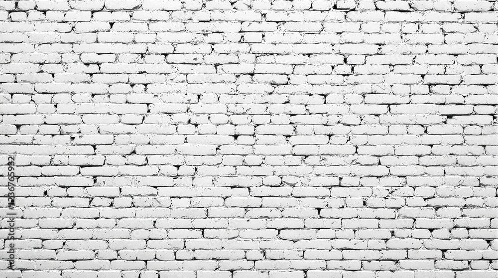 Obraz premium High-angle shot of a white grunge brick wall with a sense of depth, brick texture, worn surface, depth perception, building facade.