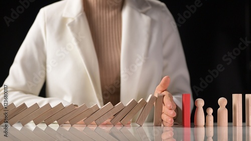 Mitigating business risks during a crisis strategic planning for growth and leadership in slow motion with hand stopping dominos falling enhancing decision making and risk management