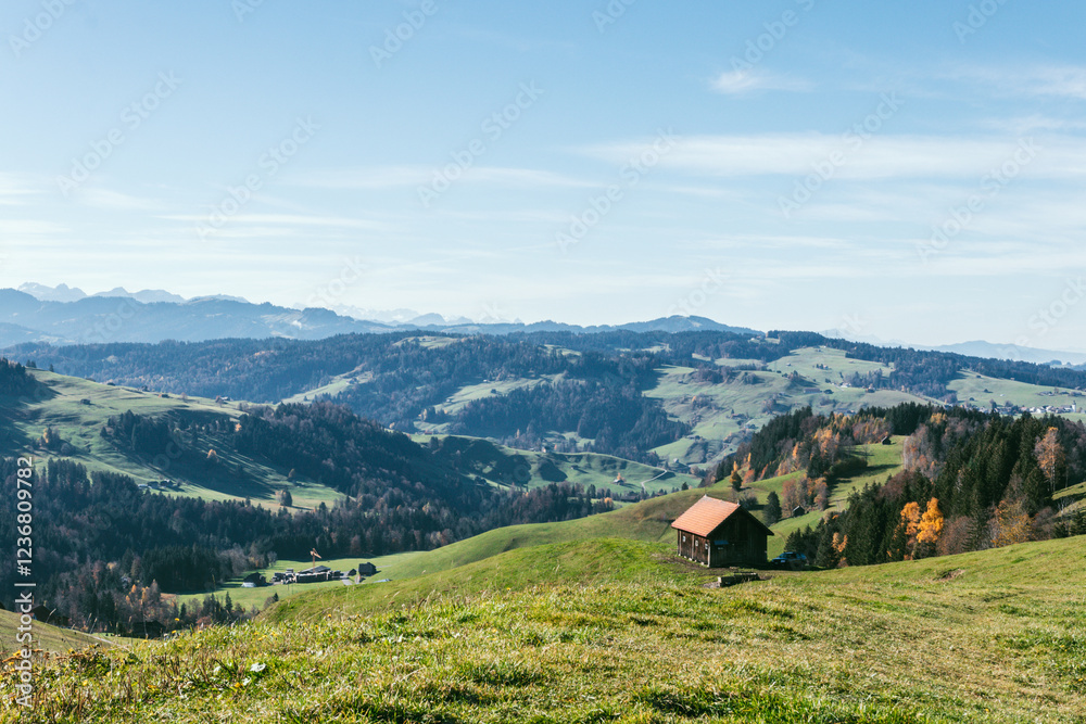 Obraz premium Idyllic Swiss Alpine Landscape with Wooden Hut and Rolling Hills