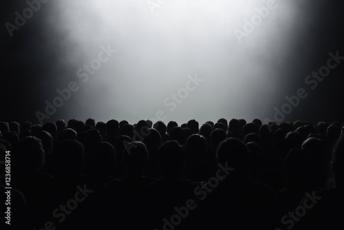A crowd of people are sitting in a dark room