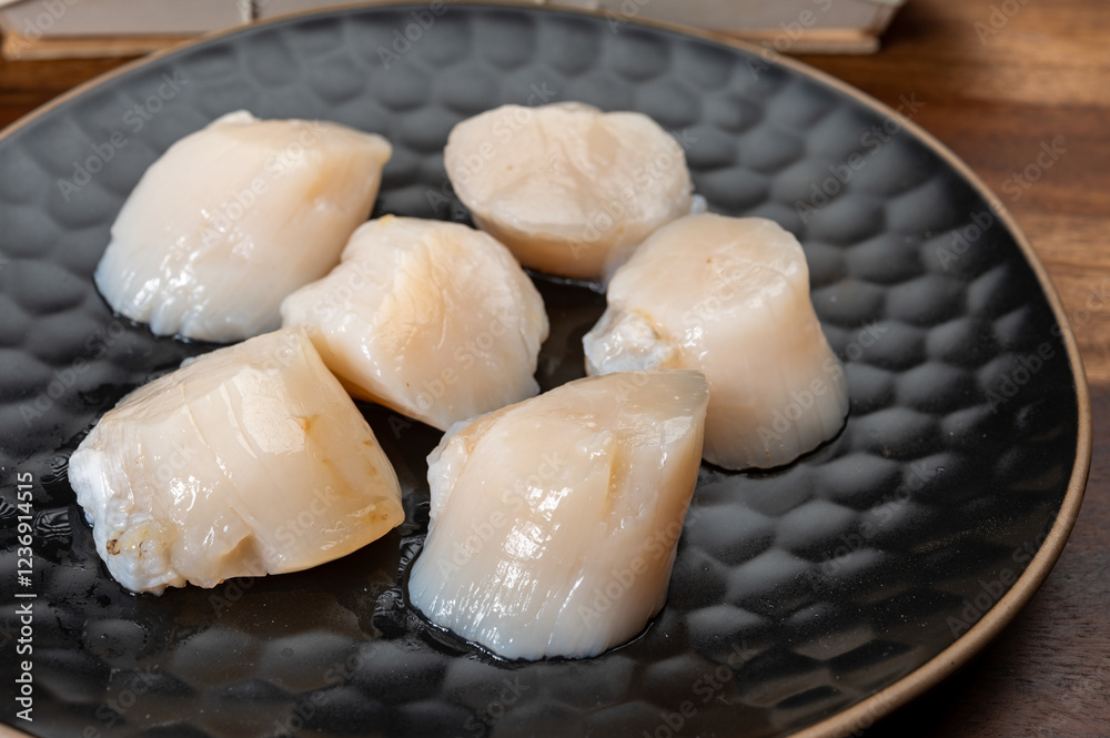 Atlantic bay scallops coquille St. James sea shells, opened in shellsand cleaned, catch of the day in Normandy or Brittany, France on fish market Atlantic bay scallops coquille St. James sea shells, opened in shellsand cleaned, catch of the day in Normandy or Brittany, France on fish market