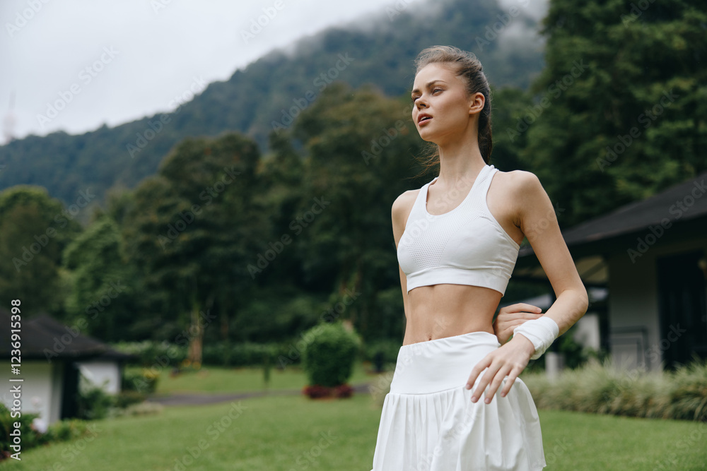 A young woman of Caucasian descent in athletic wear practicing yoga outdoors, radiating serenity and focus amidst lush green mountains, emphasizing healthy living and fitness A young woman of Caucasian descent in athletic wear practicing yoga outdoors, radiating serenity and focus amidst lush green mountains, emphasizing healthy living and fitness