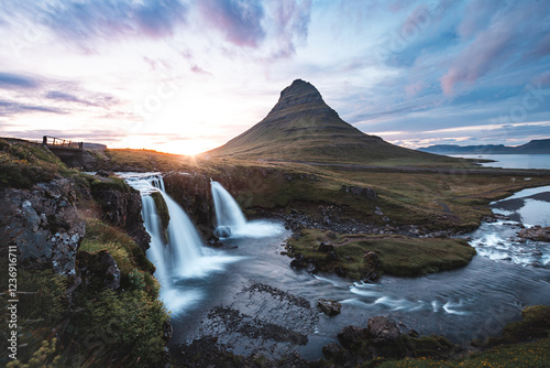 Breathtaking Kirkjufell mountain and Kirkjufellsfoss waterfall on the Snaefellsnes Peninsula, Iceland, near Grundarfjordur, with a stunning sunset backdrop photo