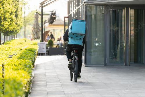 Wallpaper Mural Delivery man with backpack is riding a bicycle Torontodigital.ca