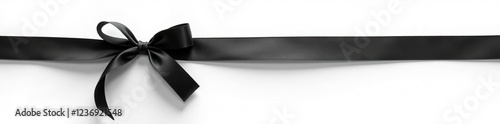 Simple black ribbon tied in a bow on a white background, white, funeral