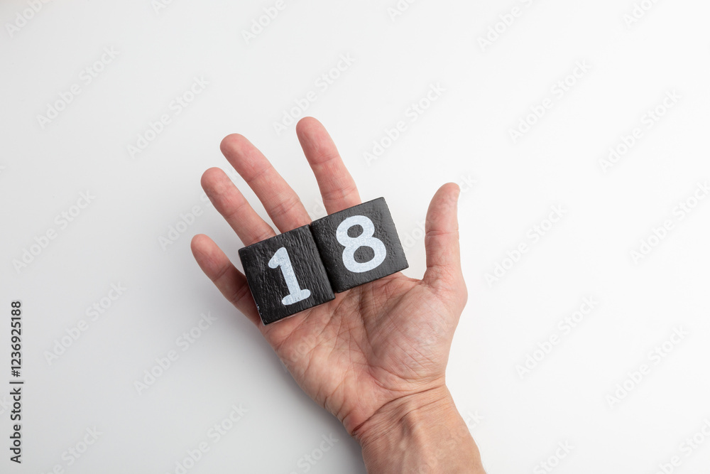 Hand Holding Wooden Blocks Showing Numbers One and Eight on White Background Hand Holding Wooden Blocks Showing Numbers One and Eight on White Background