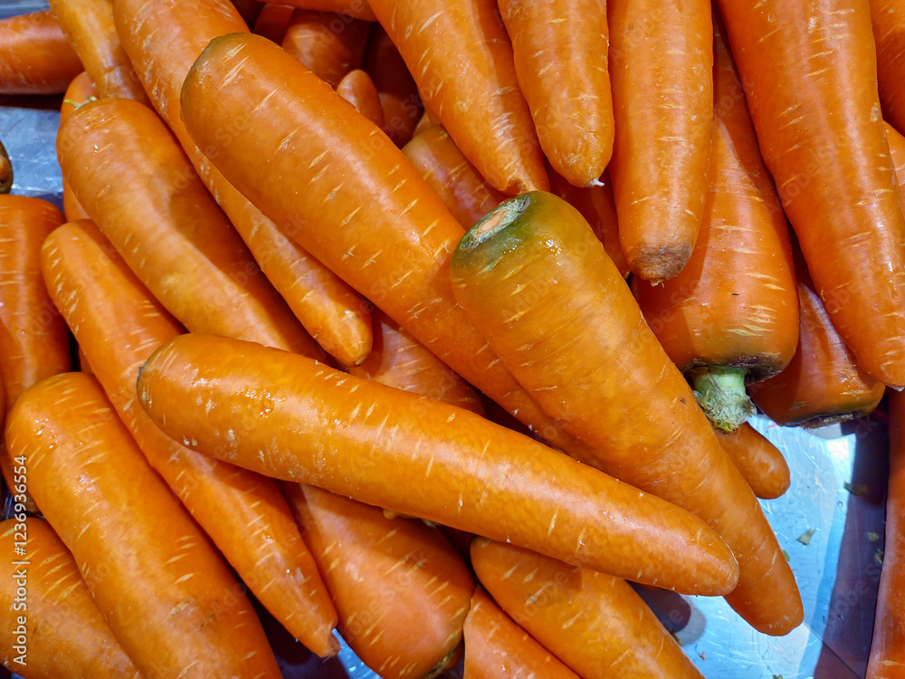 bunch of carrots displayed for sale at a market bunch of carrots displayed for sale at a market