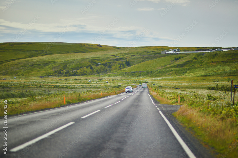 Car driving on a road surrounded by beautiful landscape in Iceland. Car driving on a road surrounded by beautiful landscape in Iceland.