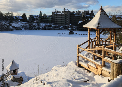 sunset view of famous hotel and wooden gazebo along hiking trail in upstate new york near new paltz (shawangunk mountain) winter snow house mohonk preserve frozen lake hike blizzard photo