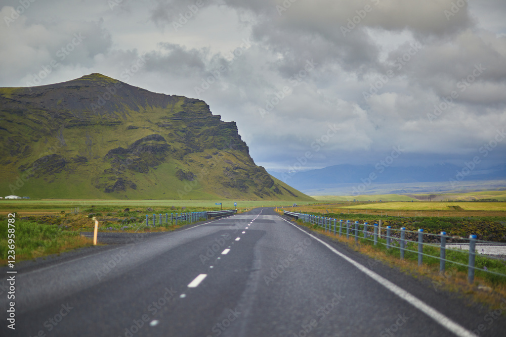 Fototapeta premium Beautiful nature landscape with green fields and majestic cliffs with ice and snow in Southern Iceland.