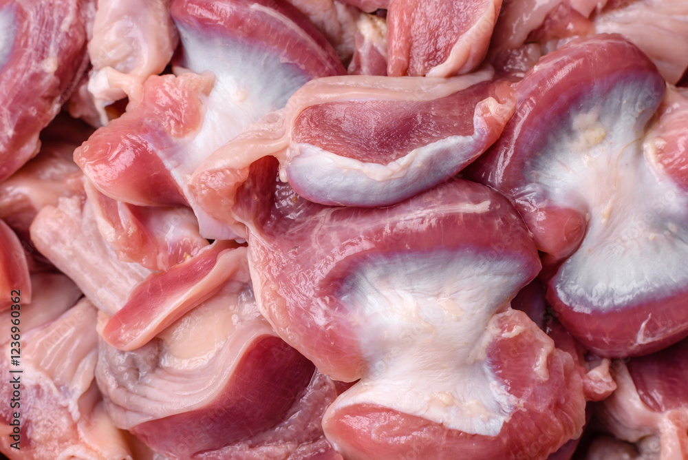Raw chicken or turkey gizzards with salt, spices and herbs Raw chicken or turkey gizzards with salt, spices and herbs