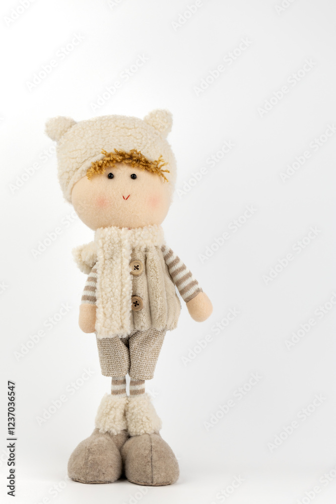 close-up on white background there is a toy under the Christmas tree, a boy in beige clothes, a hat in a scarf, modern cartoon New Year's decor close-up on white background there is a toy under the Christmas tree, a boy in beige clothes, a hat in a scarf, modern cartoon New Year's decor