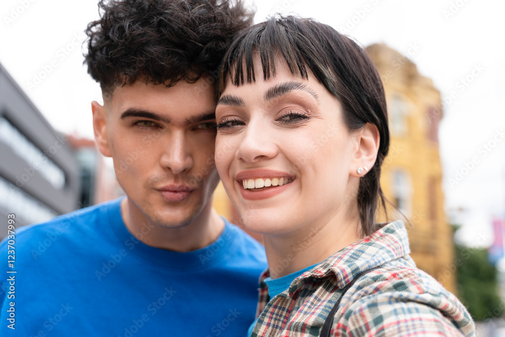 Lively couple enjoying a sunny day in the city while taking a close-up selfie together Lively couple enjoying a sunny day in the city while taking a close-up selfie together