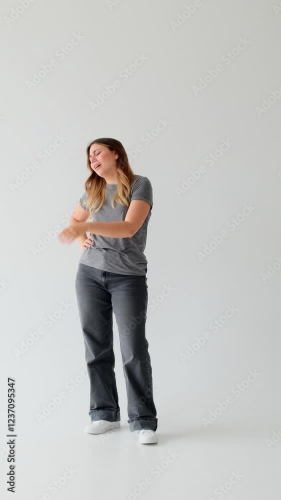 Discontent Caucasian young adult woman suffering from boredom and apathy on white background. Concept of a melancholy, loneliness and exhaustion. Vertical video. Discontent Caucasian young adult woman suffering from boredom and apathy on white background. Concept of a melancholy, loneliness and exhaustion. Vertical video.