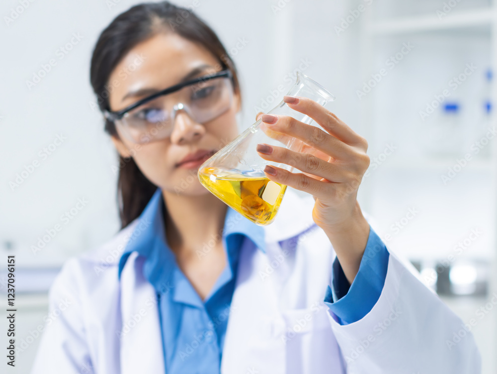 Professional Asian Female scientist uses a flask to study liquid Simples conducts detailed chemical research contributing to medical research and pharmaceutical development in a laboratory. Professional Asian Female scientist uses a flask to study liquid Simples conducts detailed chemical research contributing to medical research and pharmaceutical development in a laboratory.