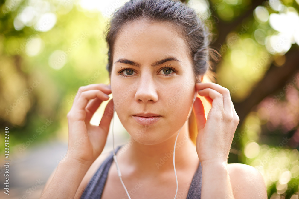 Portrait, serious and woman with earphones, fitness and streaming of music for motivation and runner. Outdoor, training and person with sportswear for exercise, listening and practice for marathon Portrait, serious and woman with earphones, fitness and streaming of music for motivation and runner. Outdoor, training and person with sportswear for exercise, listening and practice for marathon
