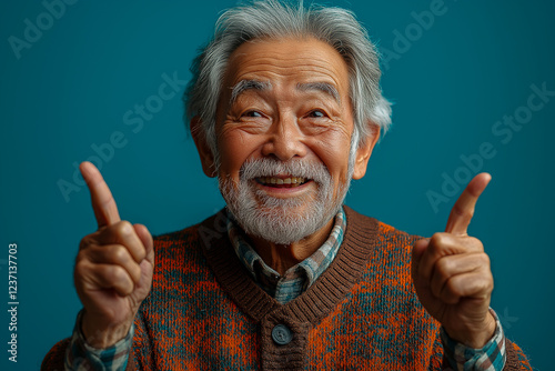 Portrait of an elderly Asian man on a blue background.