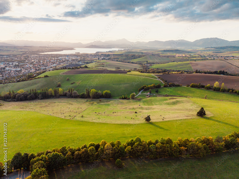 Obraz premium Sunset over Liptov region with Liptovska Mara lake and Tatras mountains around. Liptovsky mikulas landspace, slovakia.
