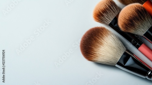 This image features a collection of diverse makeup brushes neatly organized on a soft surface, perfect for showcasing beauty and cosmetic artistry.