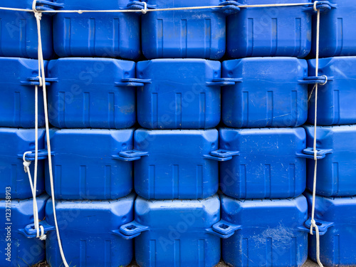 Stacked Blue Plastic Containers with Ropes, Used to Build Temporary Docks for Boats and Jet Skis in Tourist Season