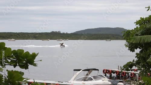 Speedboats and Jet Ski on the Costa da Lagoa, Florianópolis, Brazil on a cloudy summer day.