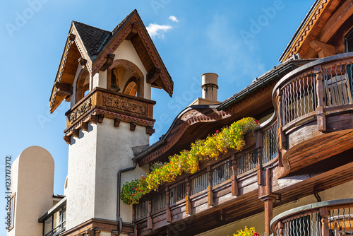 Vail, Colorado ski resort town village with blue sky and wooden tower of lodge hotel buildings in swiss architecture