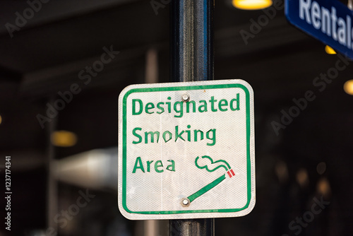 Smoking designated symbol sign in Vail, Colorado village with smoke area zone in ski resort town with symbol of cigarette