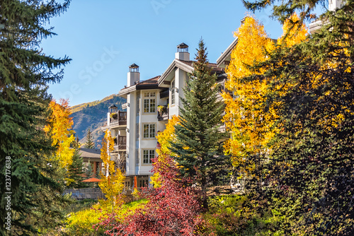 Vail, Colorado ski resort town cityscape of lodge hotel building in swiss architecture in autumn fall season multicolored red and golden Aspen leaves