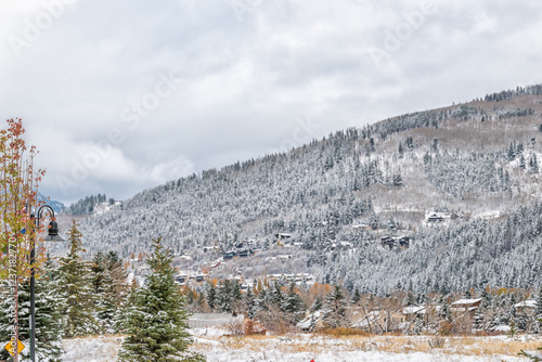 Avon Colorado ski mountain town and valley field in winter snow late fall season with mountain peak and cloudy sky photo