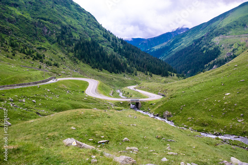 Cars on sharp turns of the serpentine Transfagarasan road. Carpathians. Romania. photo