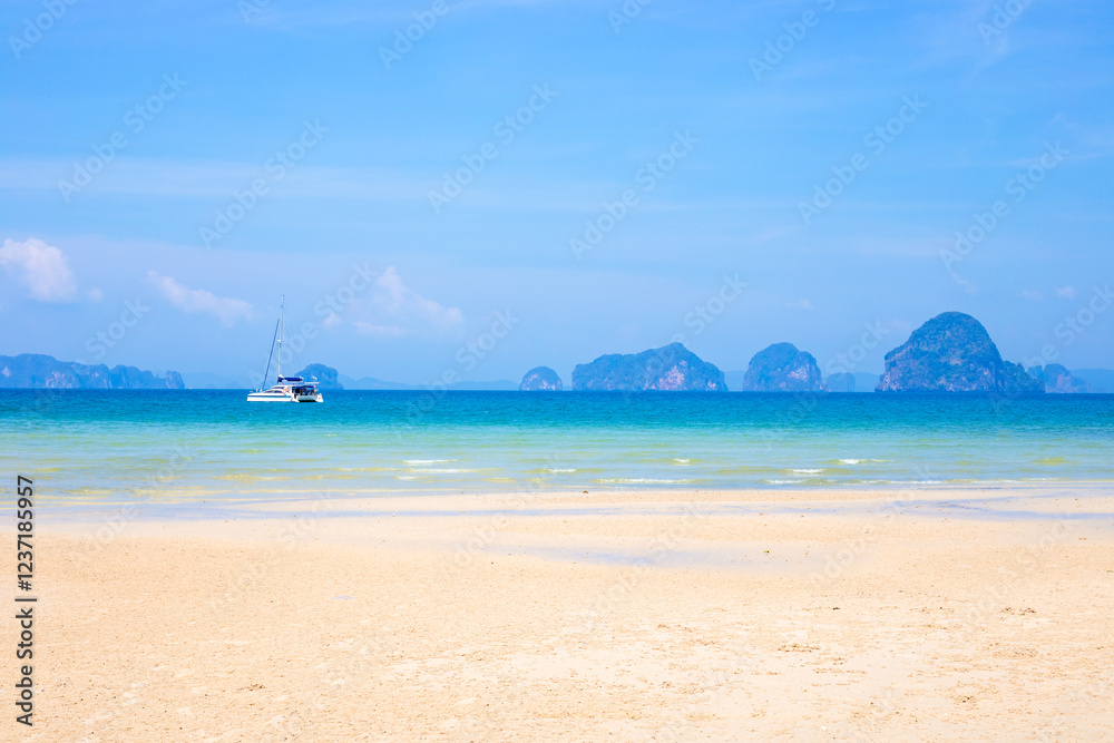Seascape. Sandy beach with boat in azure sea water and islands in the sea on the horizon in Krabi province Thailand Seascape. Sandy beach with boat in azure sea water and islands in the sea on the horizon in Krabi province Thailand