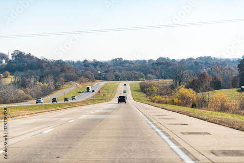 Missouri street traffic cars on highway 36 us road with blue sky and fall autumn foliage in rural countryside