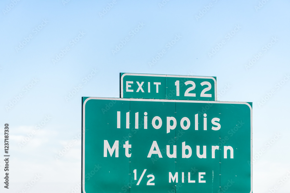 Highway 72 road in Illinois with sign exit 122 for Illiopolis and Mt Auburn in half a mile with blue sky background Highway 72 road in Illinois with sign exit 122 for Illiopolis and Mt Auburn in half a mile with blue sky background