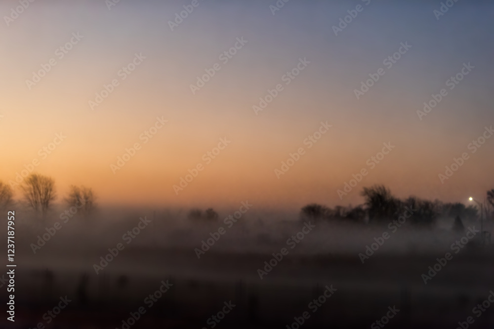 Fototapeta premium Morning dawn sunrise with lantern in abstract heavy dark mist fog on forest trees in autumn fall season landscape view in Indiana