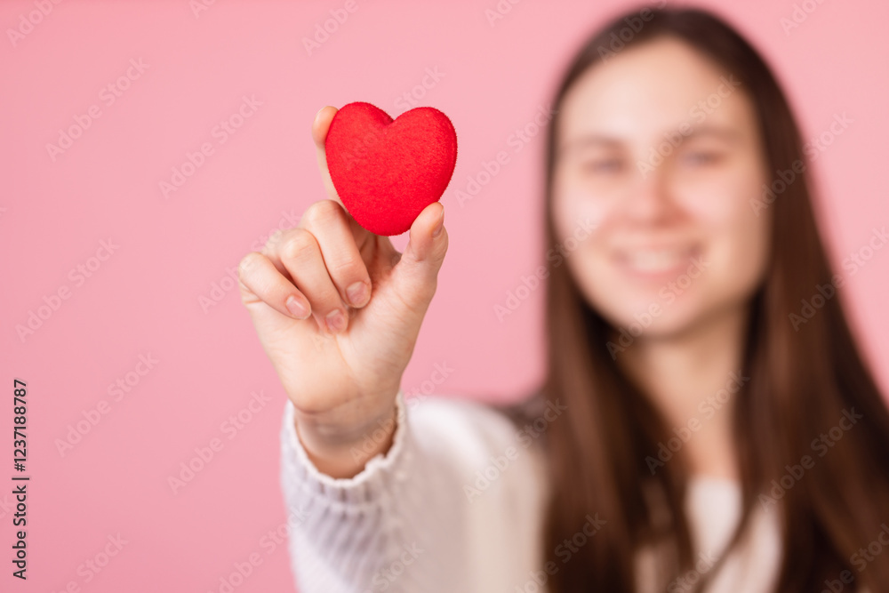 Beautiful woman hold red heart. Valentine day love concept. Studio isolated portrait of smiling woman with long hair Beautiful woman hold red heart. Valentine day love concept. Studio isolated portrait of smiling woman with long hair