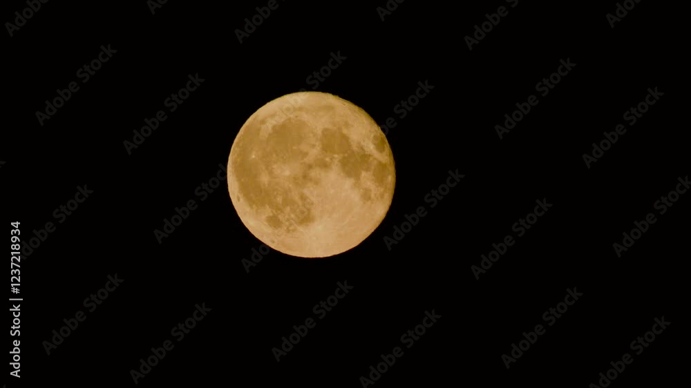 Orange full moon shimmering in the night sky