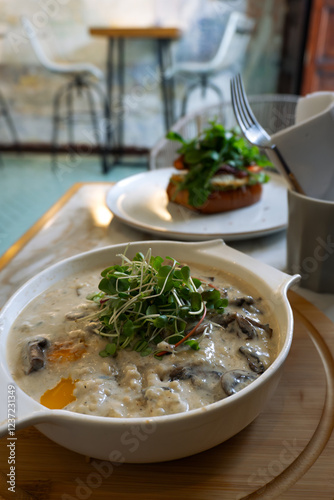 Savory Oatmeal with Mushrooms and Poached Egg in Café Setting