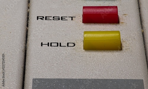 Close up of two buttons for Hold and Reset