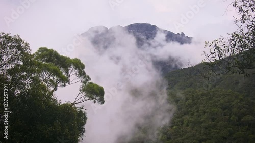 Mount Kinabalu Gayo Ngaran or Nulu Nabalu or Gunung Kinabalu is the highest mountain in Borneo and Malaysia, protected Kinabalu Park, World Heritage Site. Landscape mountain view with moving clouds. photo