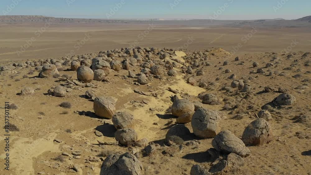 AKTAU, KAZAKHSTAN - FEBRUARY 1, 2025: Scenic views of unique spherical rock formations in the desert landscape