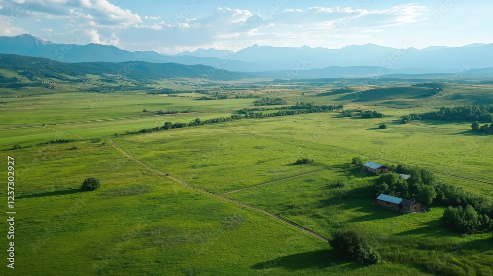 Aerial View of Serene Green Field and Mountain Range Aerial View of Serene Green Field and Mountain Range