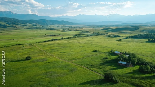 Aerial View of Serene Green Field and Mountain Range