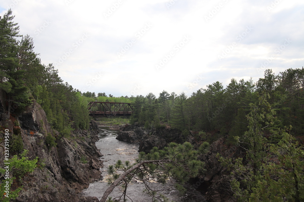 Rapid water from a waterfall underneath the pedestrian bridge at Jay Cooke State Park, Minnesota	