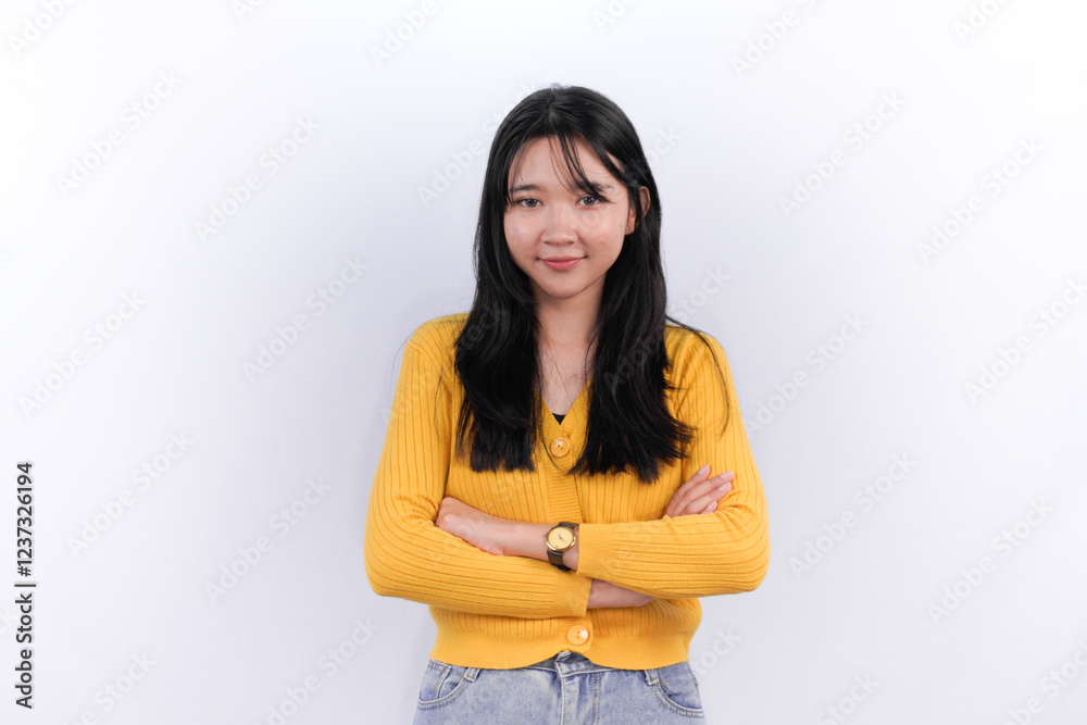Indonesian Asian woman with long black hair is hugging herself Indonesian Asian woman with long black hair is hugging herself