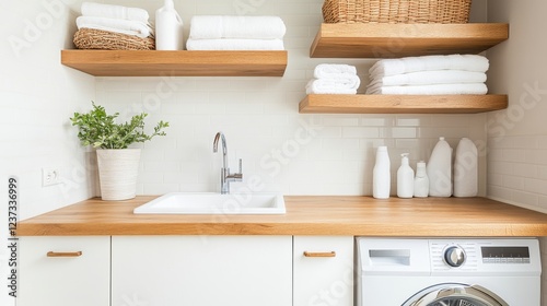 Freshly folded towels in white tones are neatly arranged on open shelves in a bright laundry room. The clean layout promotes a sense of order and relaxation.