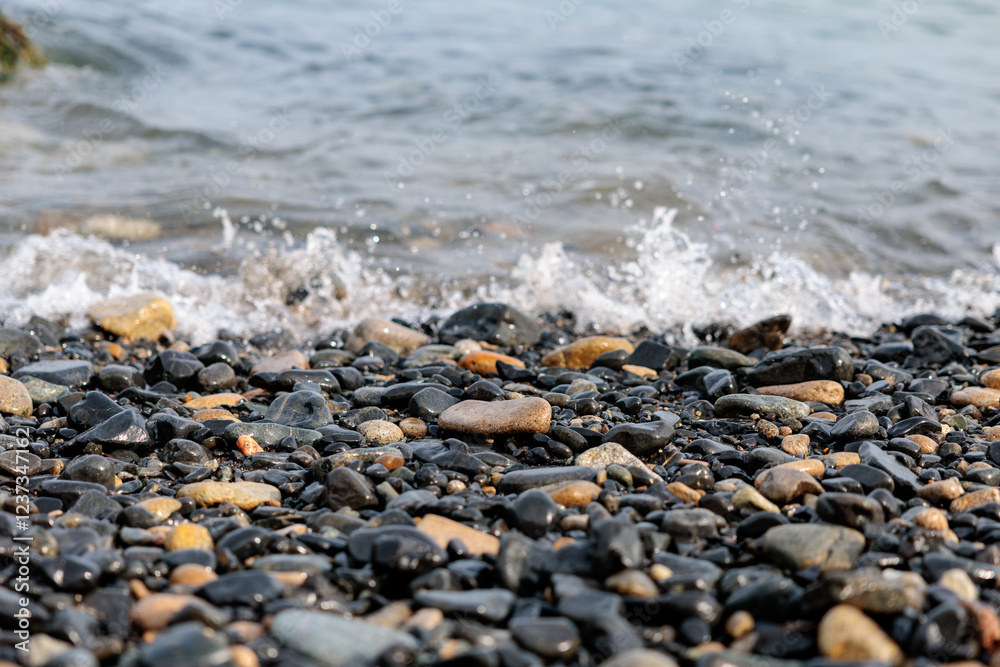 Scenery of a pebble beach with gentle waves hitting Geoje Island, Korea Scenery of a pebble beach with gentle waves hitting Geoje Island, Korea