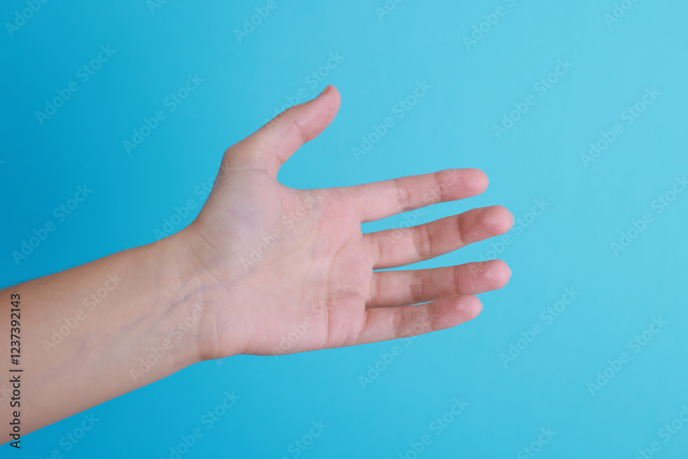 Woman with visible hand veins on light blue background, closeup Woman with visible hand veins on light blue background, closeup