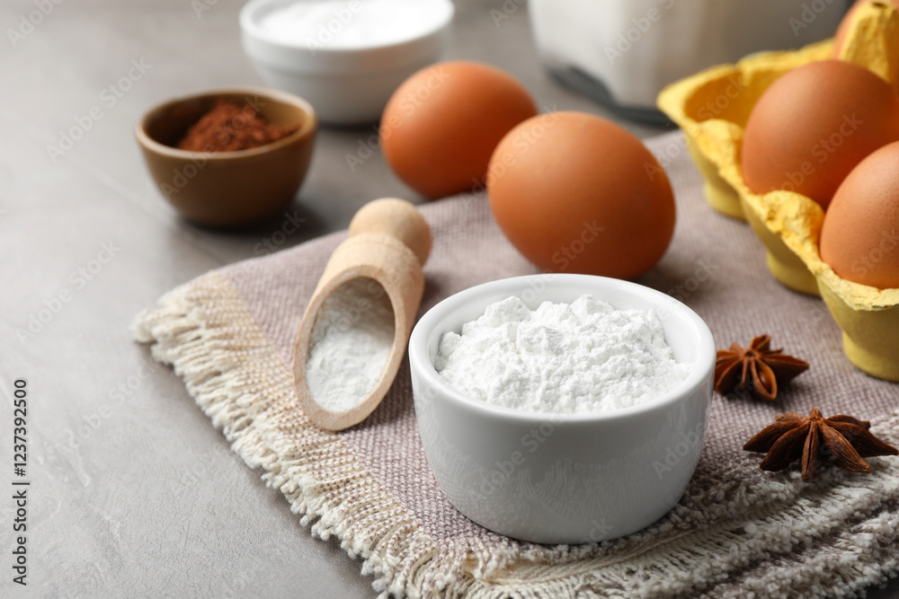 Baking powder and other products on grey textured table, closeup Baking powder and other products on grey textured table, closeup