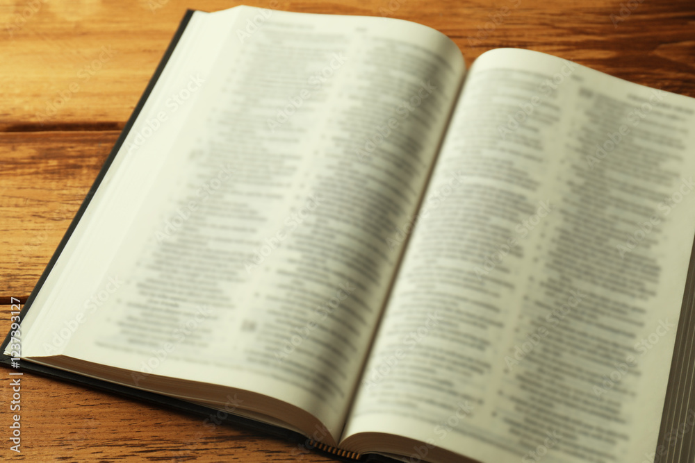 Open Holy Bible in English language on wooden table, closeup Open Holy Bible in English language on wooden table, closeup